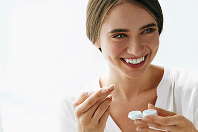 Happy Woman Preparing to Put in Contact Lenses