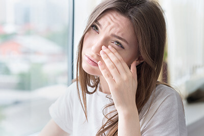 Woman Rubbing Her Eyes