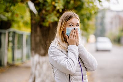 Woman wearing medical mask outdoors