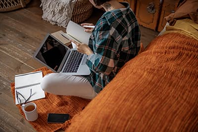 Woman working from home on floor